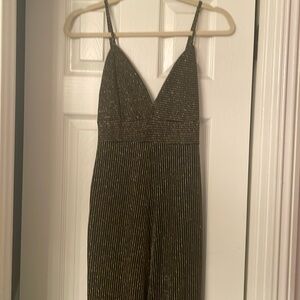 Full length romper, gold stitching with black background.